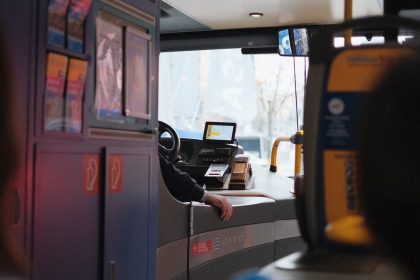 A modern bus interior showcasing the driver's area during daylight hours.