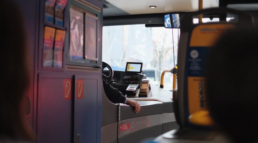 A modern bus interior showcasing the driver's area during daylight hours.